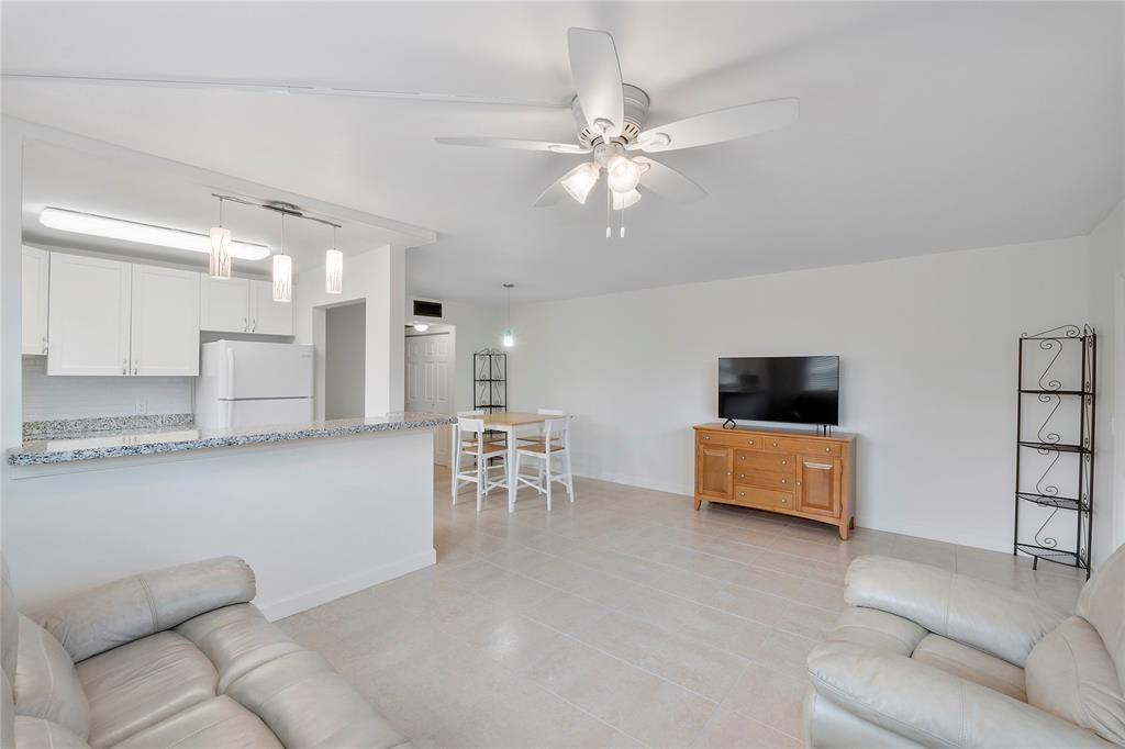 373 Tilford R, Unit 373 Deerfield Beach, FL 33442 - Photo 2 of 36 a living room with furniture and a flat screen tv