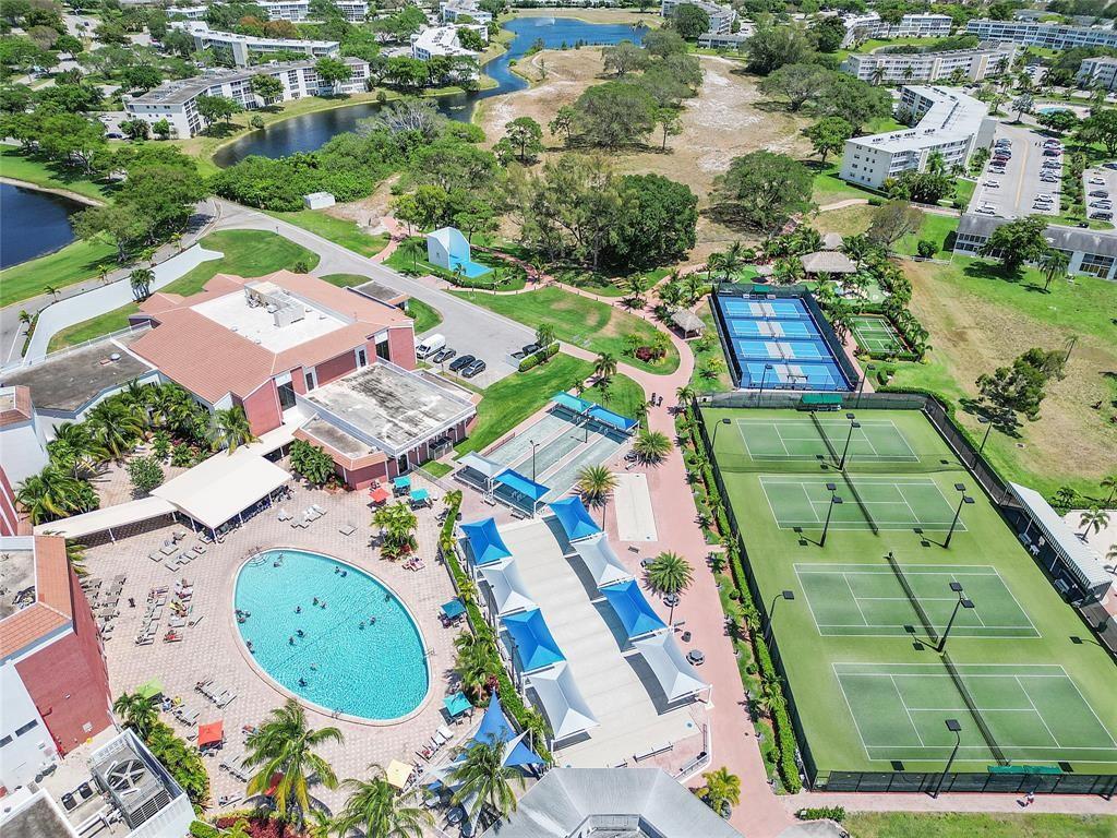 373 Tilford R, Unit 373 Deerfield Beach, FL 33442 - Photo 23 of 36 an aerial view of a swimming pool playground and residential houses with outdoor space