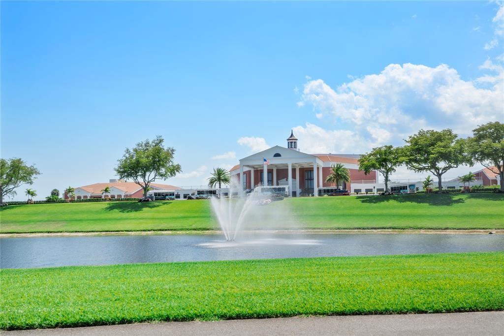373 Tilford R, Unit 373 Deerfield Beach, FL 33442 - Photo 32 of 36 a front view of a house with a garden and trees