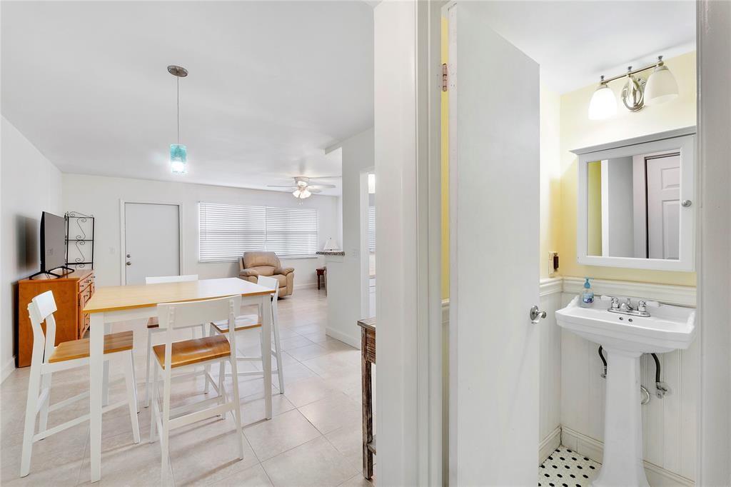 373 Tilford R, Unit 373 Deerfield Beach, FL 33442 - Photo 8 of 36 a view of a kitchen with dining table and chairs