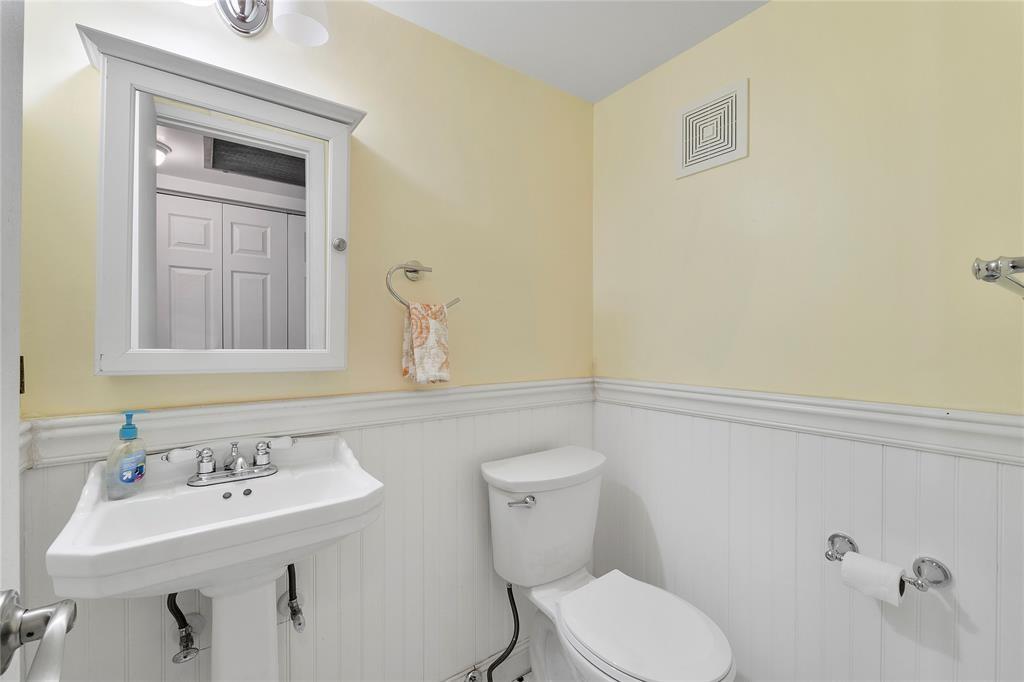 373 Tilford R, Unit 373 Deerfield Beach, FL 33442 - Photo 9 of 36 a bathroom with a sink a toilet and mirror