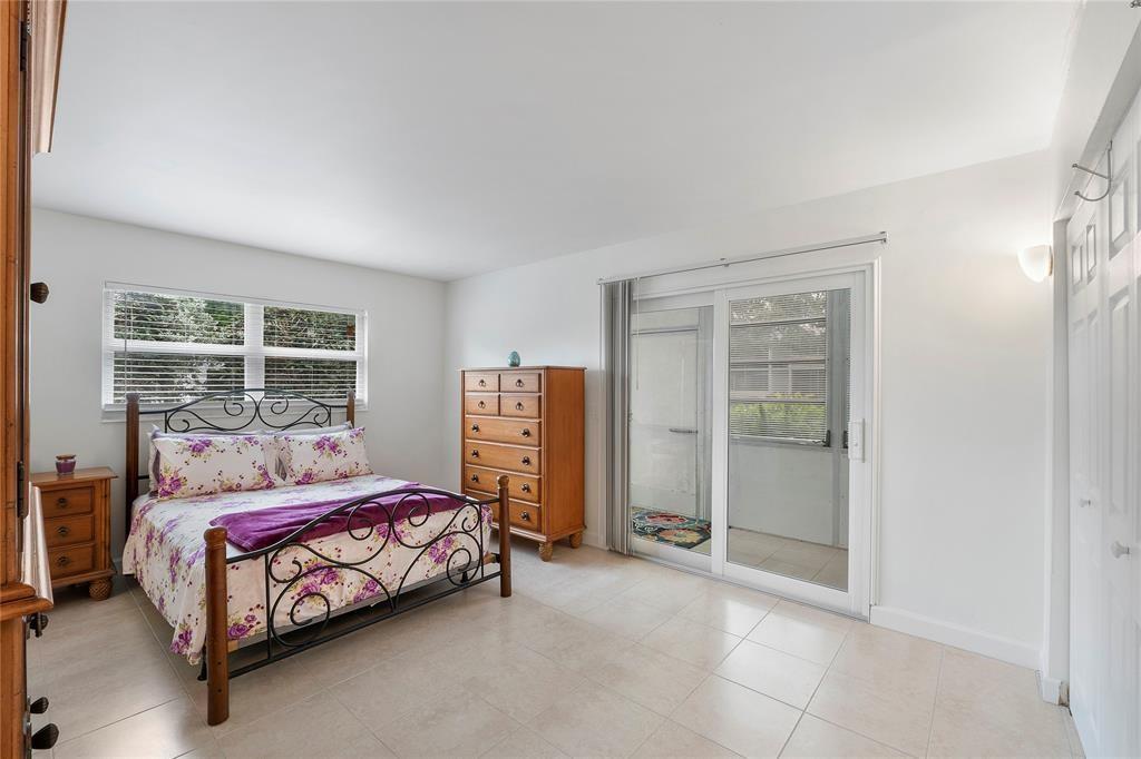 373 Tilford R, Unit 373 Deerfield Beach, FL 33442 - Photo 10 of 36 a bedroom with a bed and a walk in closet