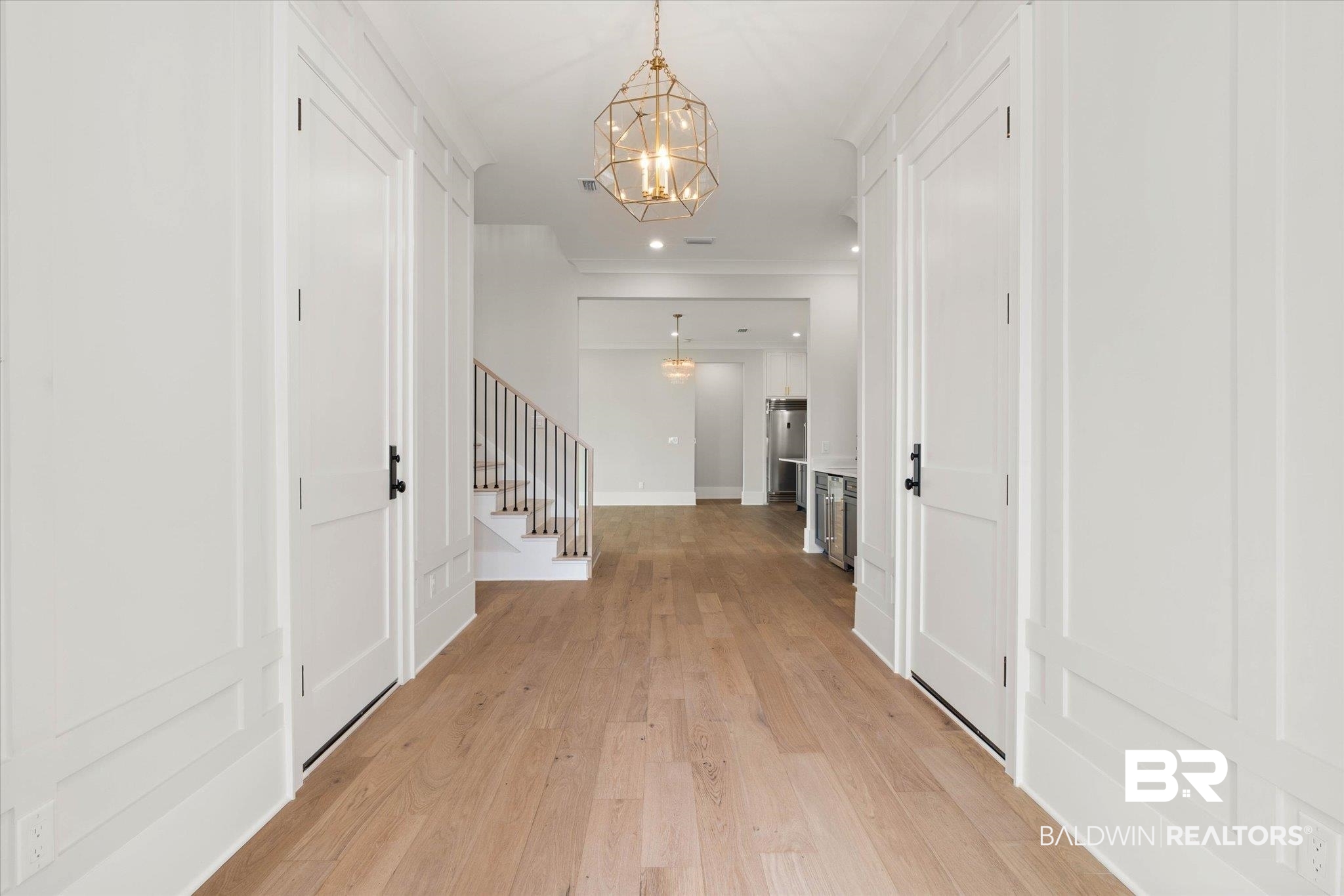 853 Inlet Circle Gulf Shores, AL 36542 - Photo 2 of 55 Hallway featuring recessed lighting, a notable chandelier, stairway, and light wood-style floors