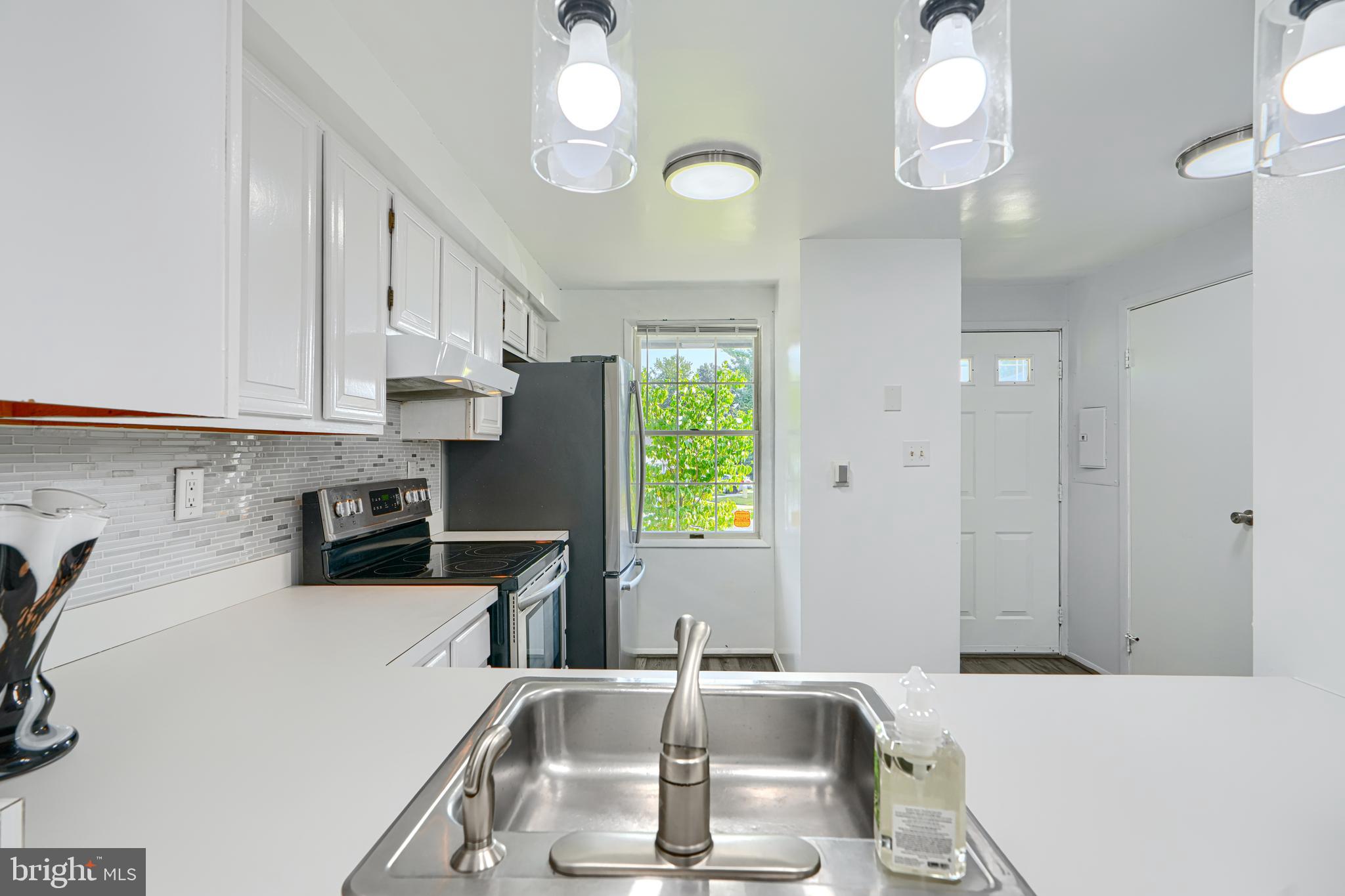 6 Stillwood Circle Nottingham, MD 21236 - Photo 12 of 26 a kitchen with stainless steel appliances a sink a counter space and cabinets