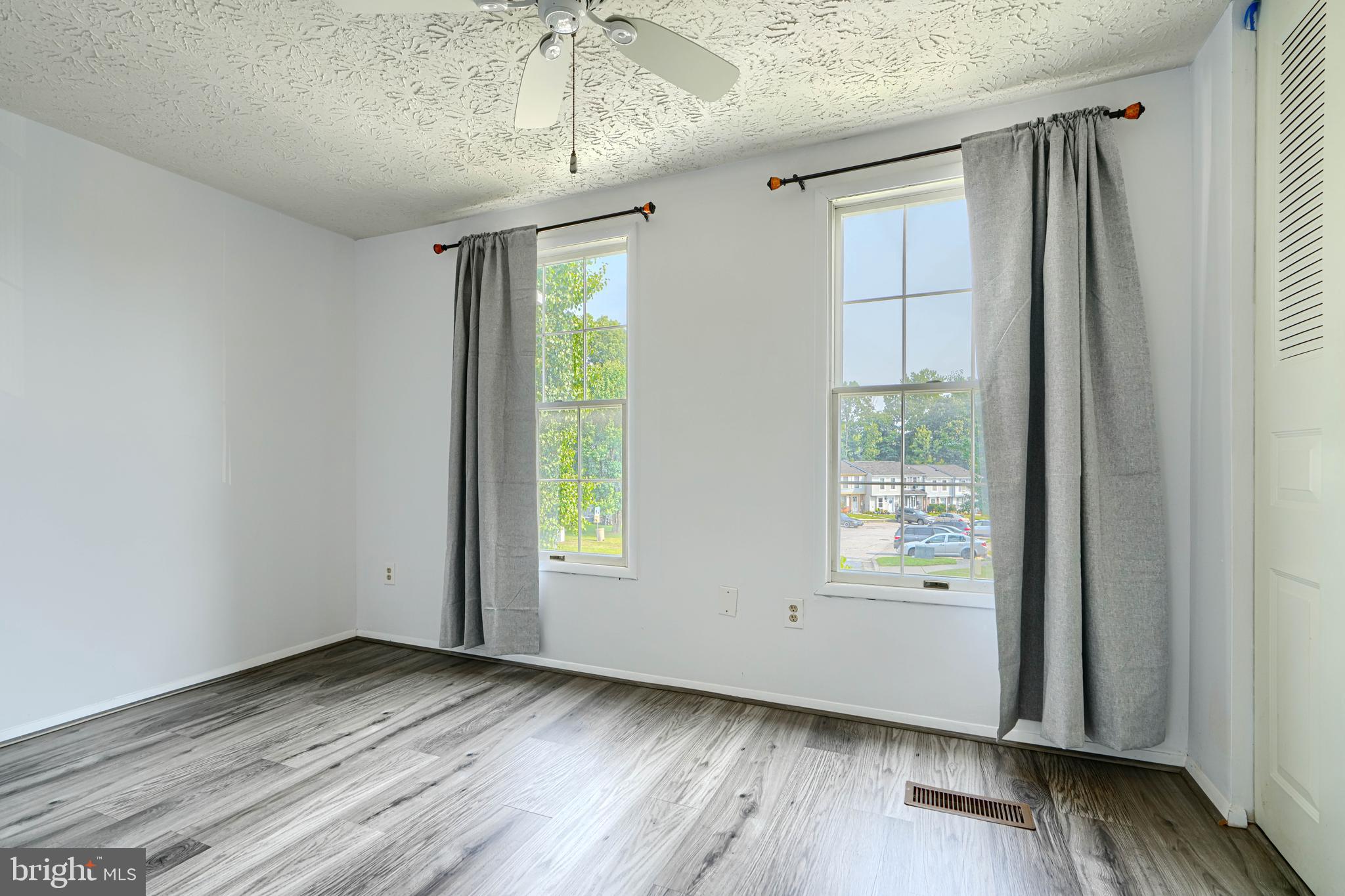 6 Stillwood Circle Nottingham, MD 21236 - Photo 15 of 26 an empty room with wooden floor and windows