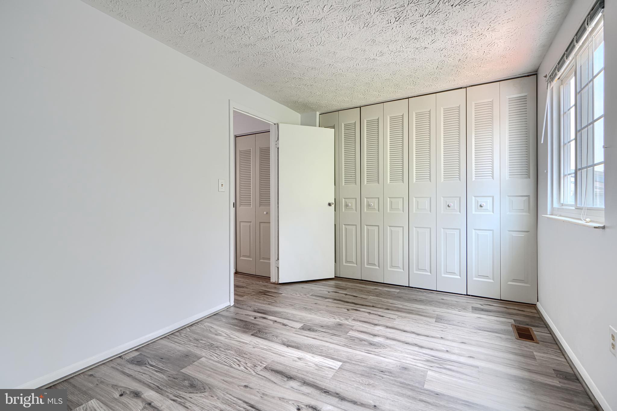 6 Stillwood Circle Nottingham, MD 21236 - Photo 19 of 26 a view of empty room with wooden floor and fan