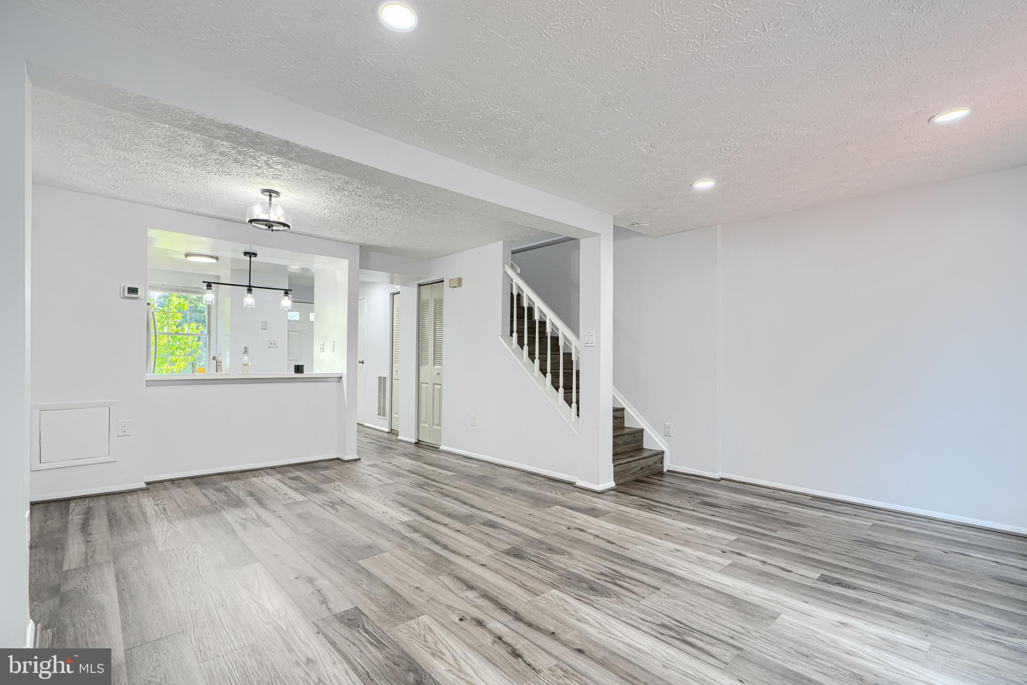 6 Stillwood Circle Nottingham, MD 21236 - Photo 8 of 26 an empty room with wooden floor and windows