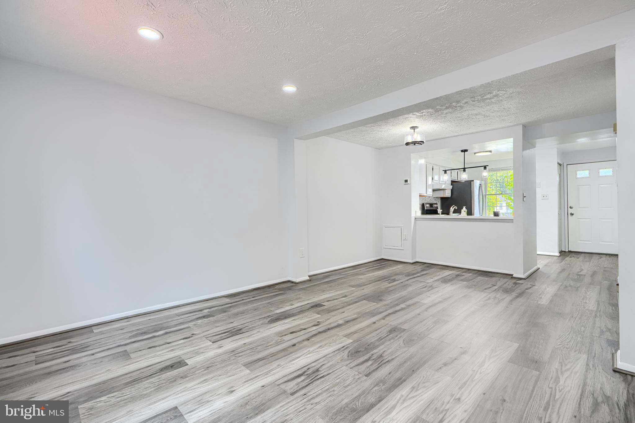 6 Stillwood Circle Nottingham, MD 21236 - Photo 10 of 26 a view of a big room with wooden floor and windows