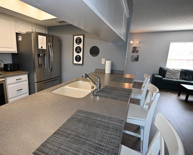 5348 Saddlebrook Way, Unit 2 Wesley Chapel, FL 33543 - Photo 12 of 38 a bedroom with a bed and wooden floor