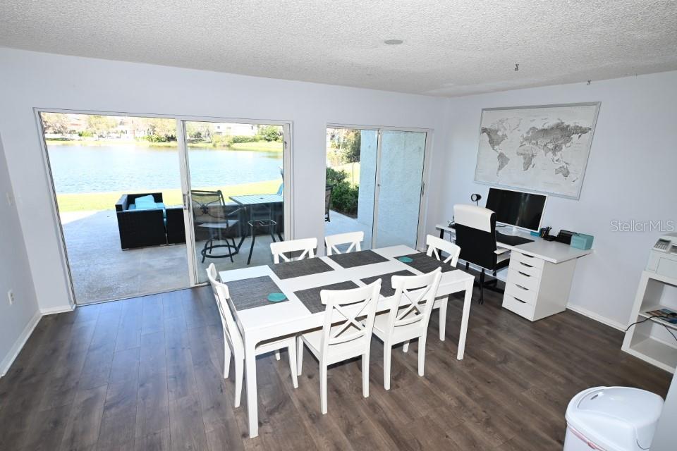 5348 Saddlebrook Way, Unit 2 Wesley Chapel, FL 33543 - Photo 13 of 38 a view of a dining room with furniture window and wooden floor
