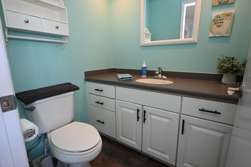 5348 Saddlebrook Way, Unit 2 Wesley Chapel, FL 33543 - Photo 18 of 38 a bathroom with a toilet sink and mirror