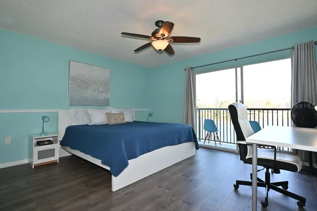 a living room with a bed furniture and a large window