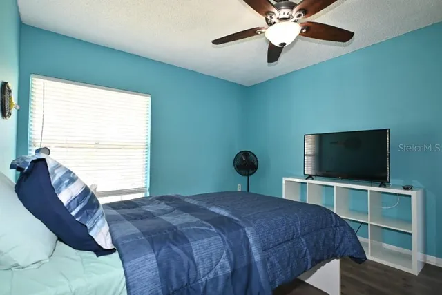 a bedroom with a bed and a flat screen tv