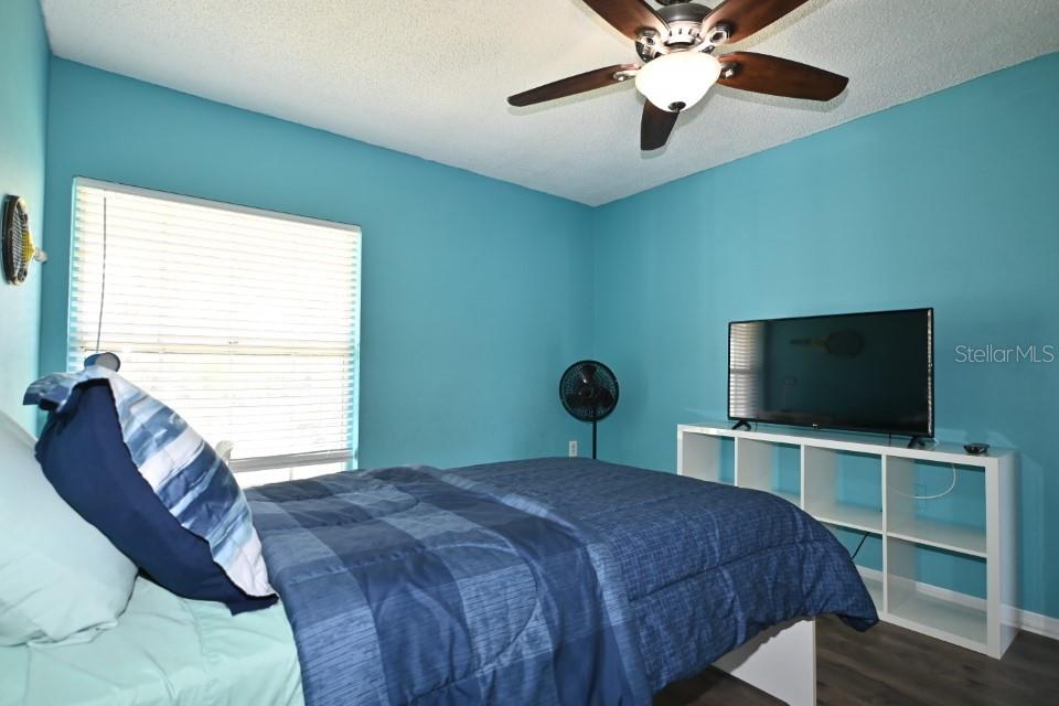 5348 Saddlebrook Way, Unit 2 Wesley Chapel, FL 33543 - Photo 28 of 38 a bedroom with a bed and a flat screen tv