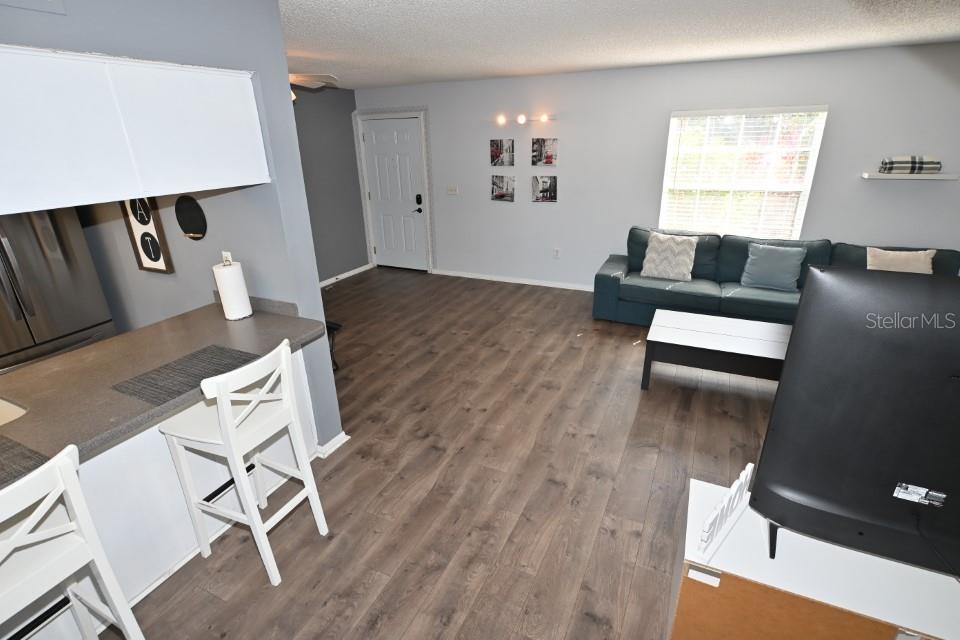 5348 Saddlebrook Way, Unit 2 Wesley Chapel, FL 33543 - Photo 7 of 38 a living room with furniture and wooden floor