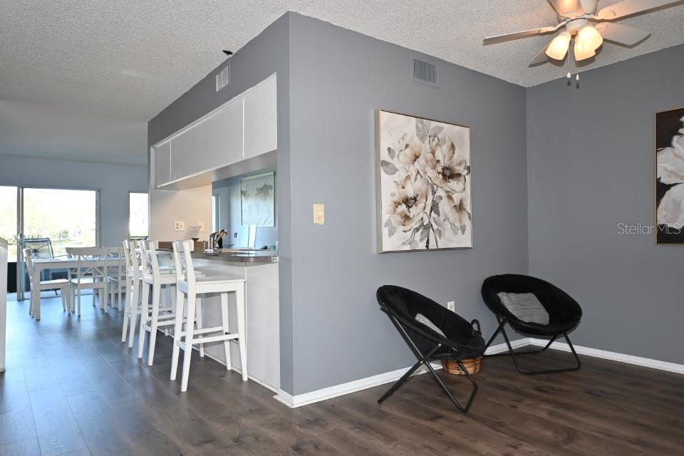 5348 Saddlebrook Way, Unit 2 Wesley Chapel, FL 33543 - Photo 8 of 38 a view of a dining room with furniture and wooden floor