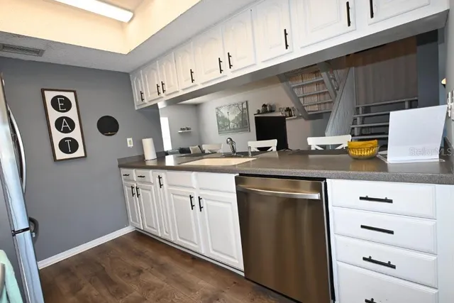 a kitchen with stainless steel appliances granite countertop a sink and a stove