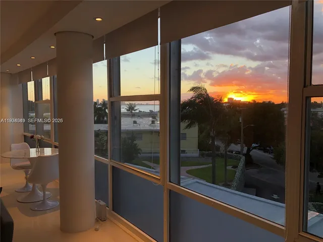 a view of a glass door and a yard from a balcony