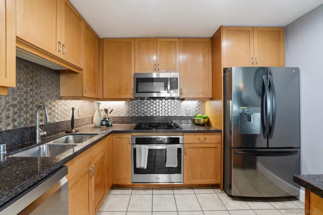 a kitchen with a refrigerator sink and stove