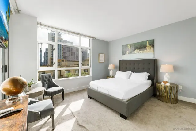 a bedroom with a bed a table and chair