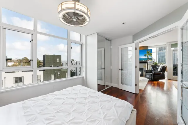 a bedroom with a large bed and a large window