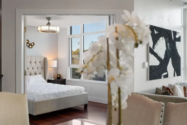 a bedroom with a bed and a chandelier