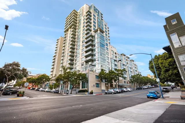 a view of a tall building next to a road