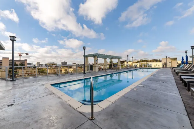 a view of a roof deck with couches and potted plants