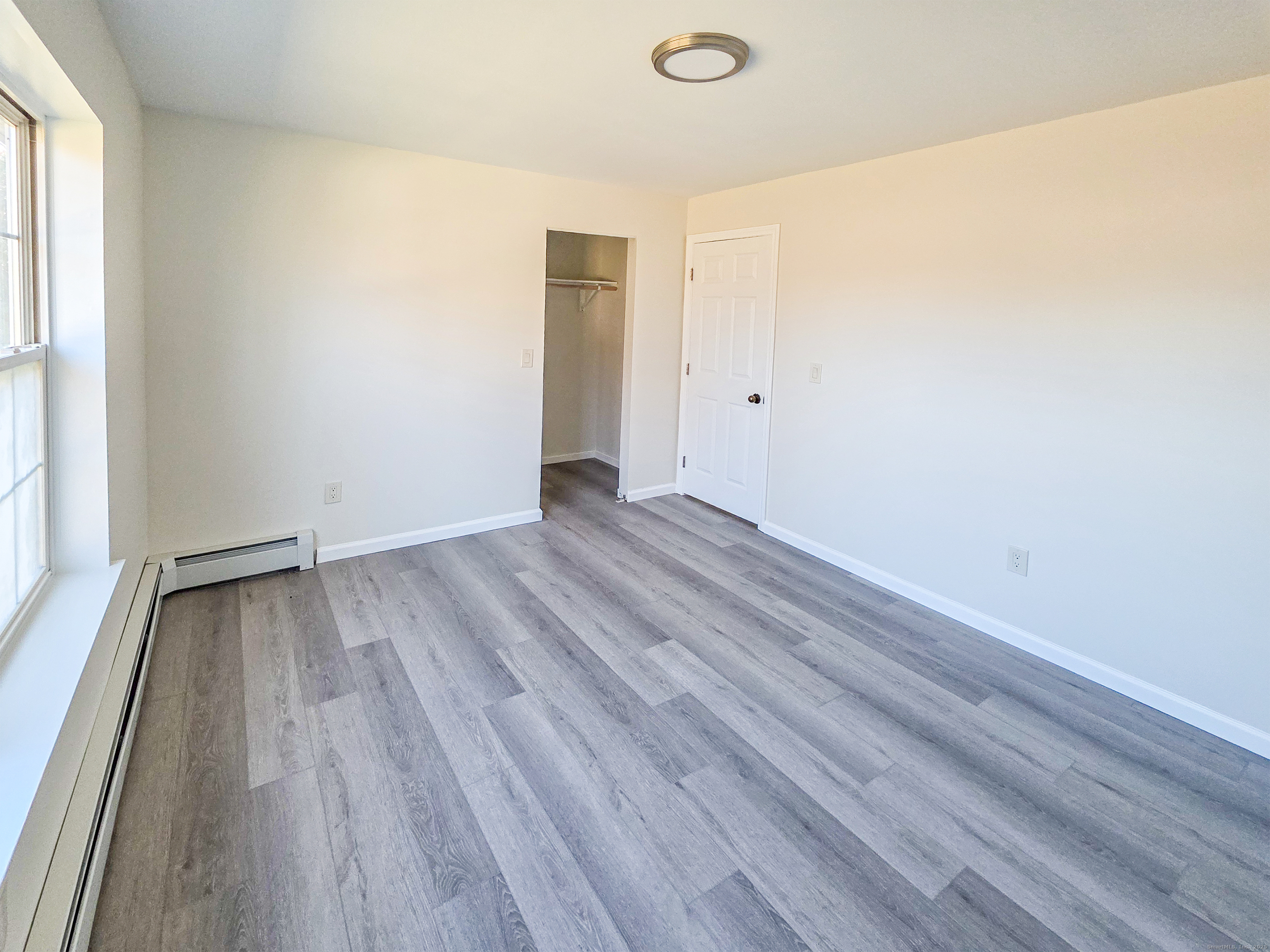 7 Dally Farm Road Windsor, CT 06095 - Photo 14 of 23 a view of an empty room with wooden floor and a window