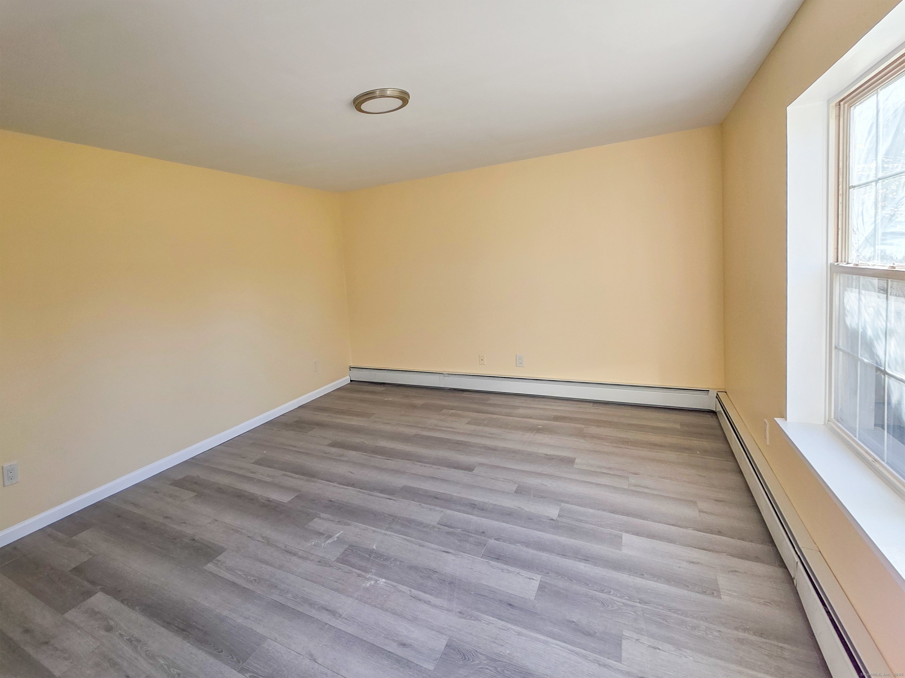 7 Dally Farm Road Windsor, CT 06095 - Photo 19 of 23 a view of an empty room with wooden floor and a window