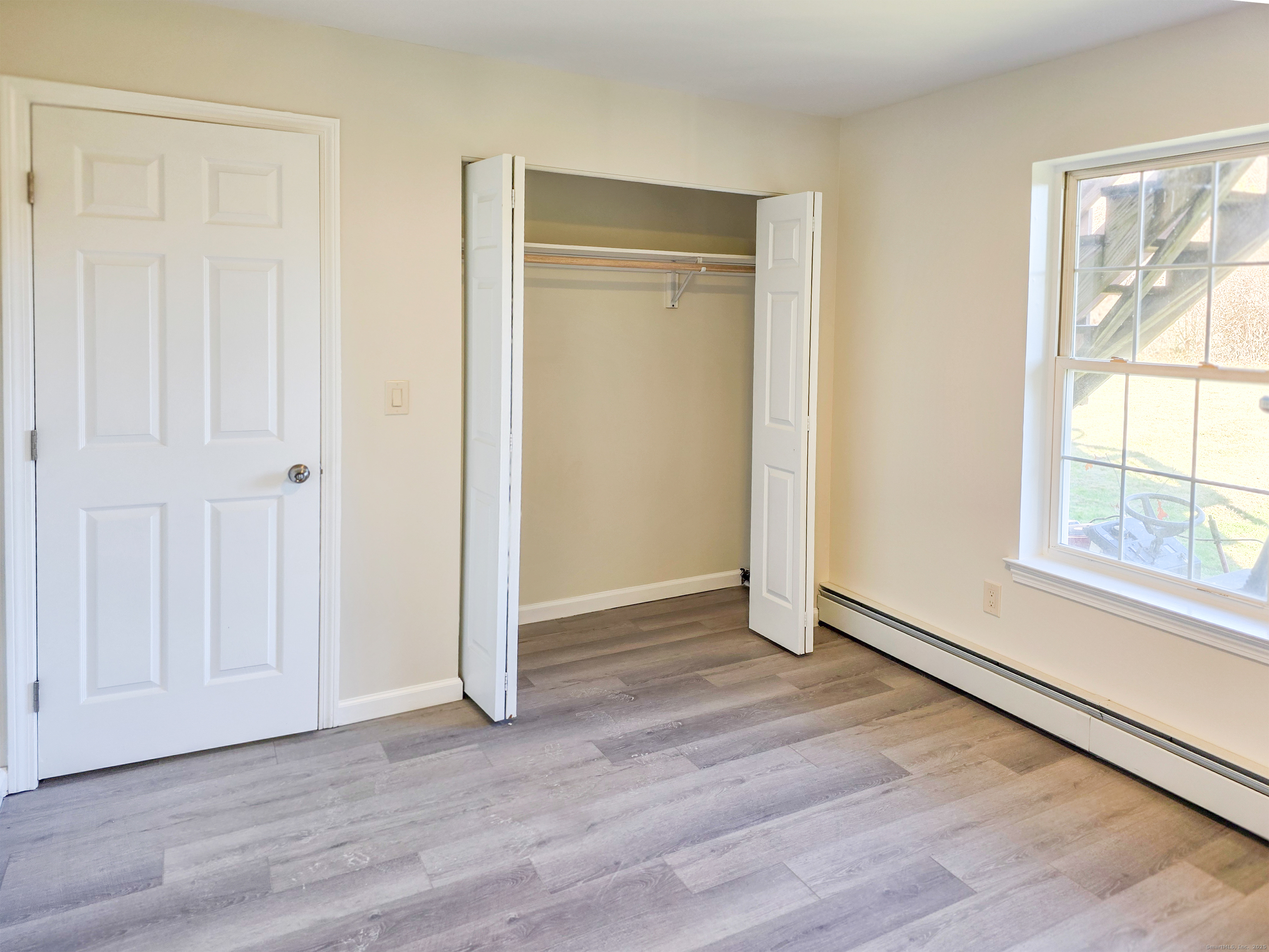 7 Dally Farm Road Windsor, CT 06095 - Photo 20 of 23 an empty room with wooden floor and windows