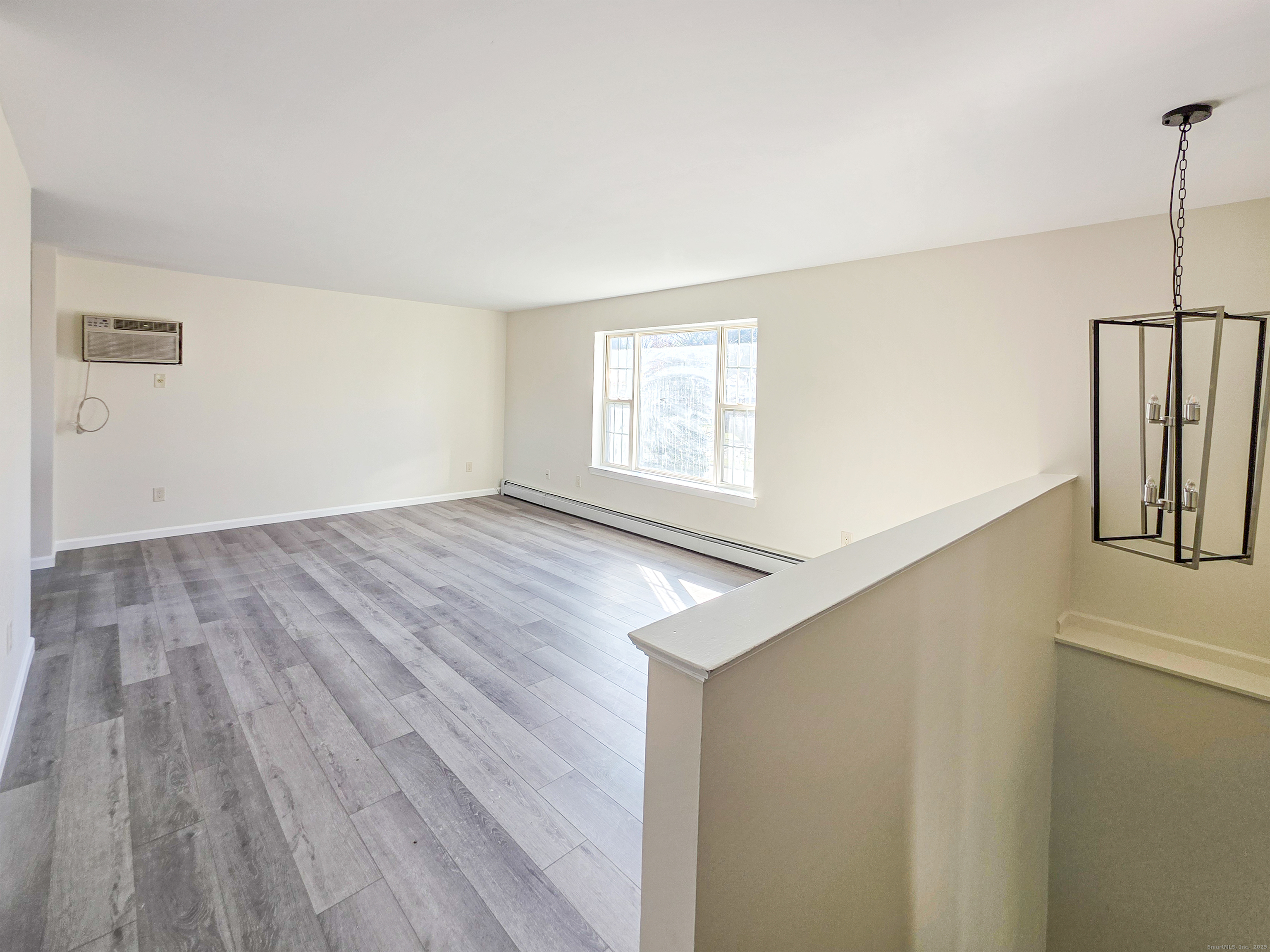 7 Dally Farm Road Windsor, CT 06095 - Photo 7 of 23 a view of an empty room with wooden floor and a window