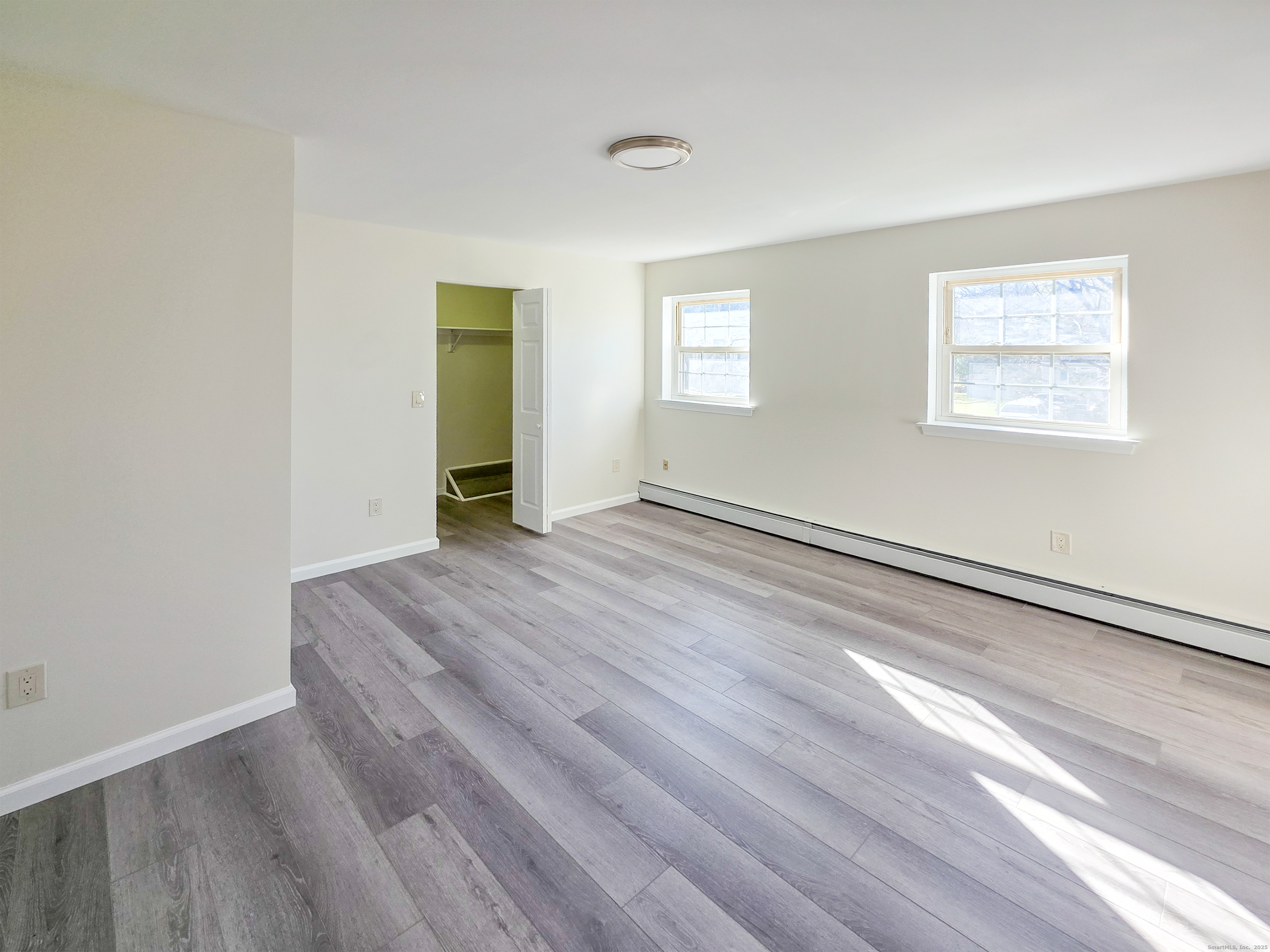 7 Dally Farm Road Windsor, CT 06095 - Photo 9 of 23 a view of an empty room with wooden floor and a window