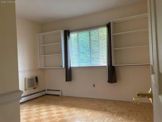 a view of a room with rack on the wall and a window