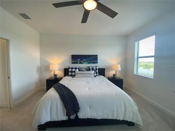 a bedroom with a bed and window