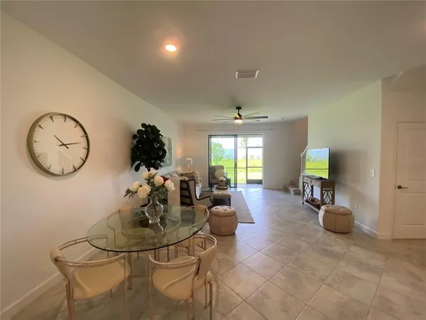 a living room with dining table and chairs