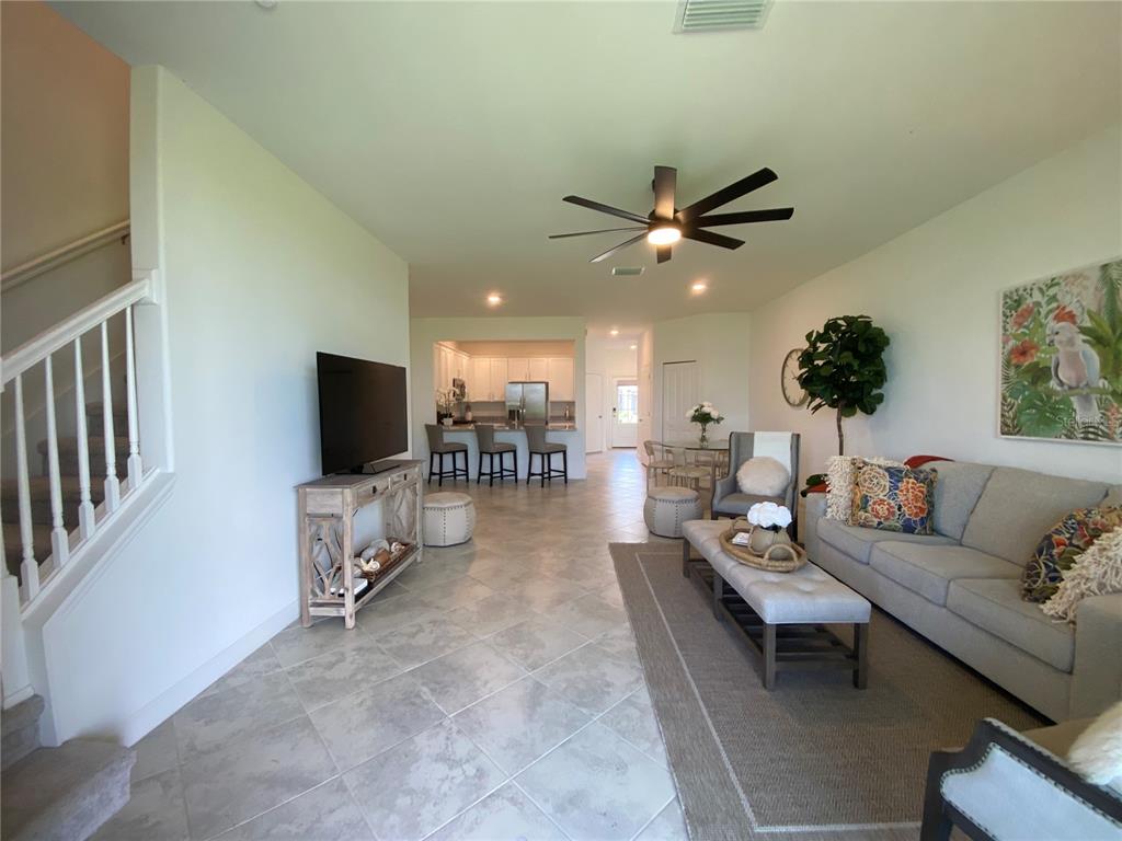 15216 Lyla Terrace Lakewood Ranch, FL 34211 - Photo 6 of 15 a living room with furniture and a flat screen tv