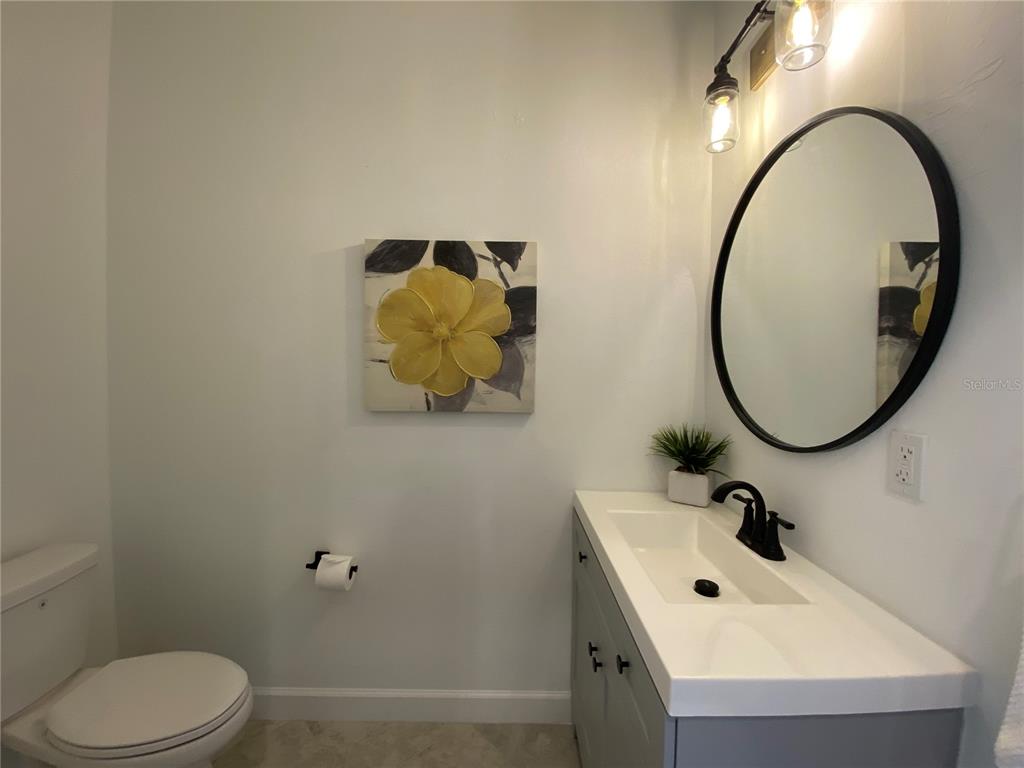 15216 Lyla Terrace Lakewood Ranch, FL 34211 - Photo 8 of 15 a bathroom with a sink and mirror with toilet