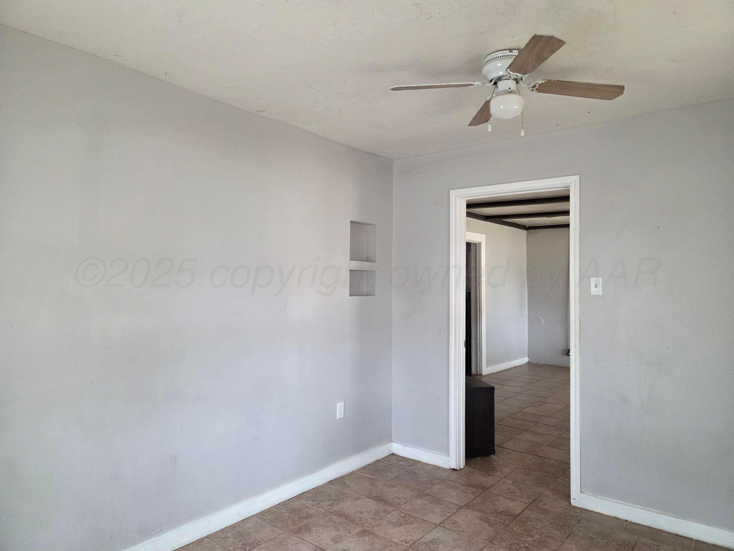 231 Main Street Quitaque, TX 79255 - Photo 14 of 23 a view of a hallway with a chandelier fan