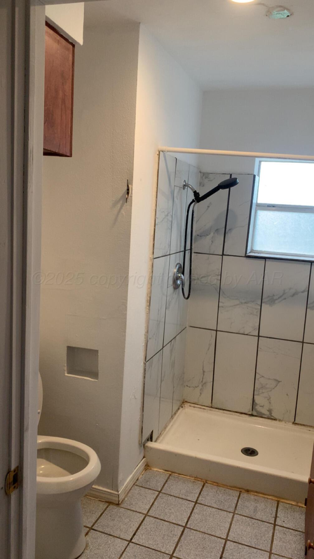 231 Main Street Quitaque, TX 79255 - Photo 17 of 23 a bathroom with a shower and toilet