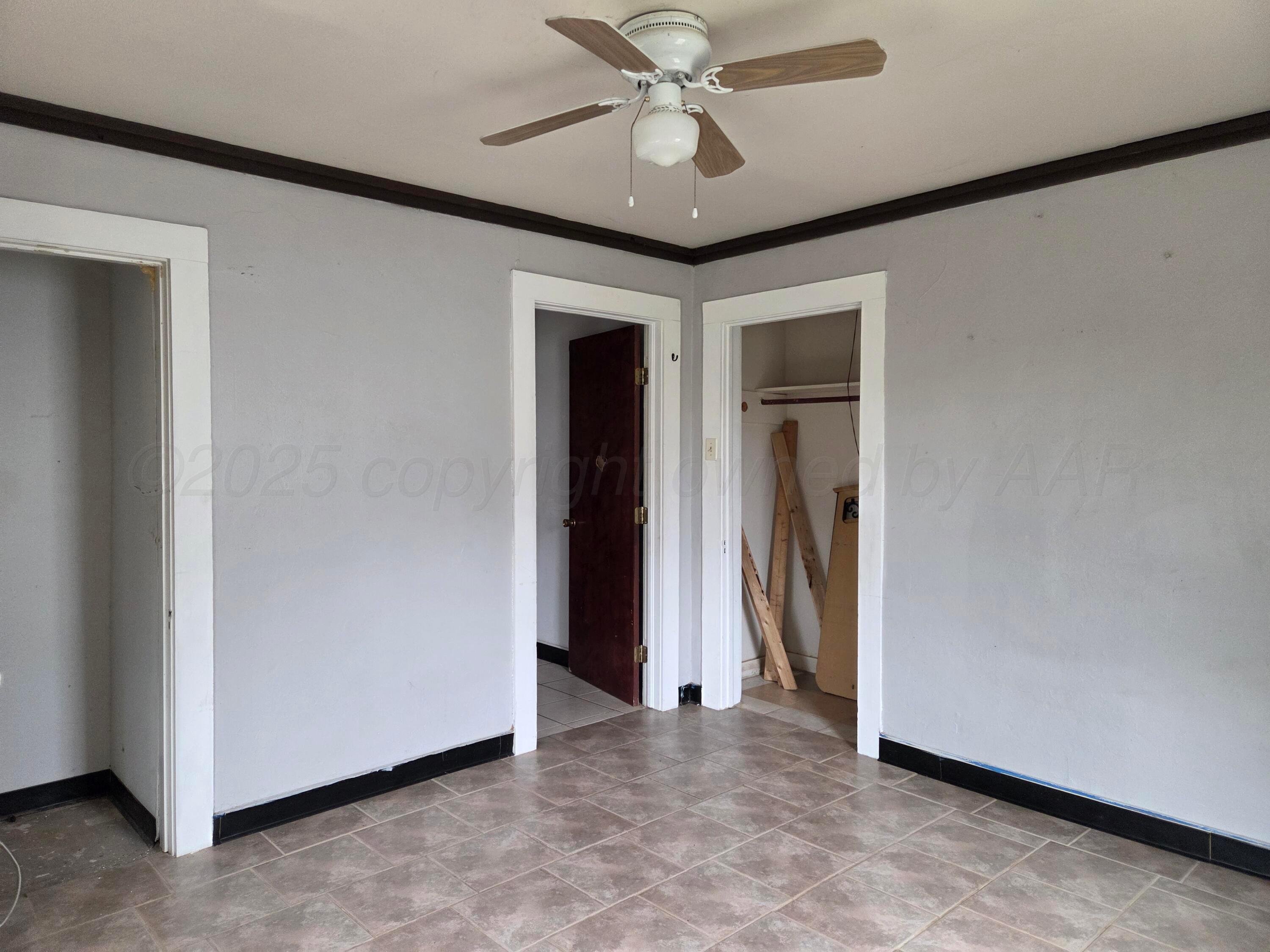 231 Main Street Quitaque, TX 79255 - Photo 19 of 23 a view of a hallway with a chandelier fan