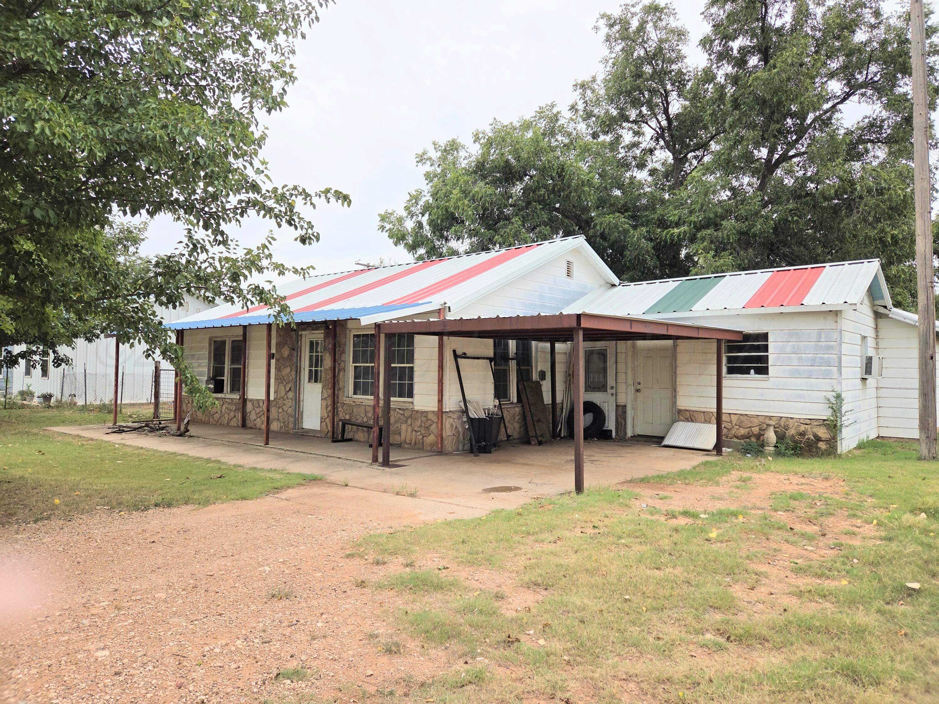 231 Main Street Quitaque, TX 79255 - Photo 2 of 23 a front view of a house with a yard and trees