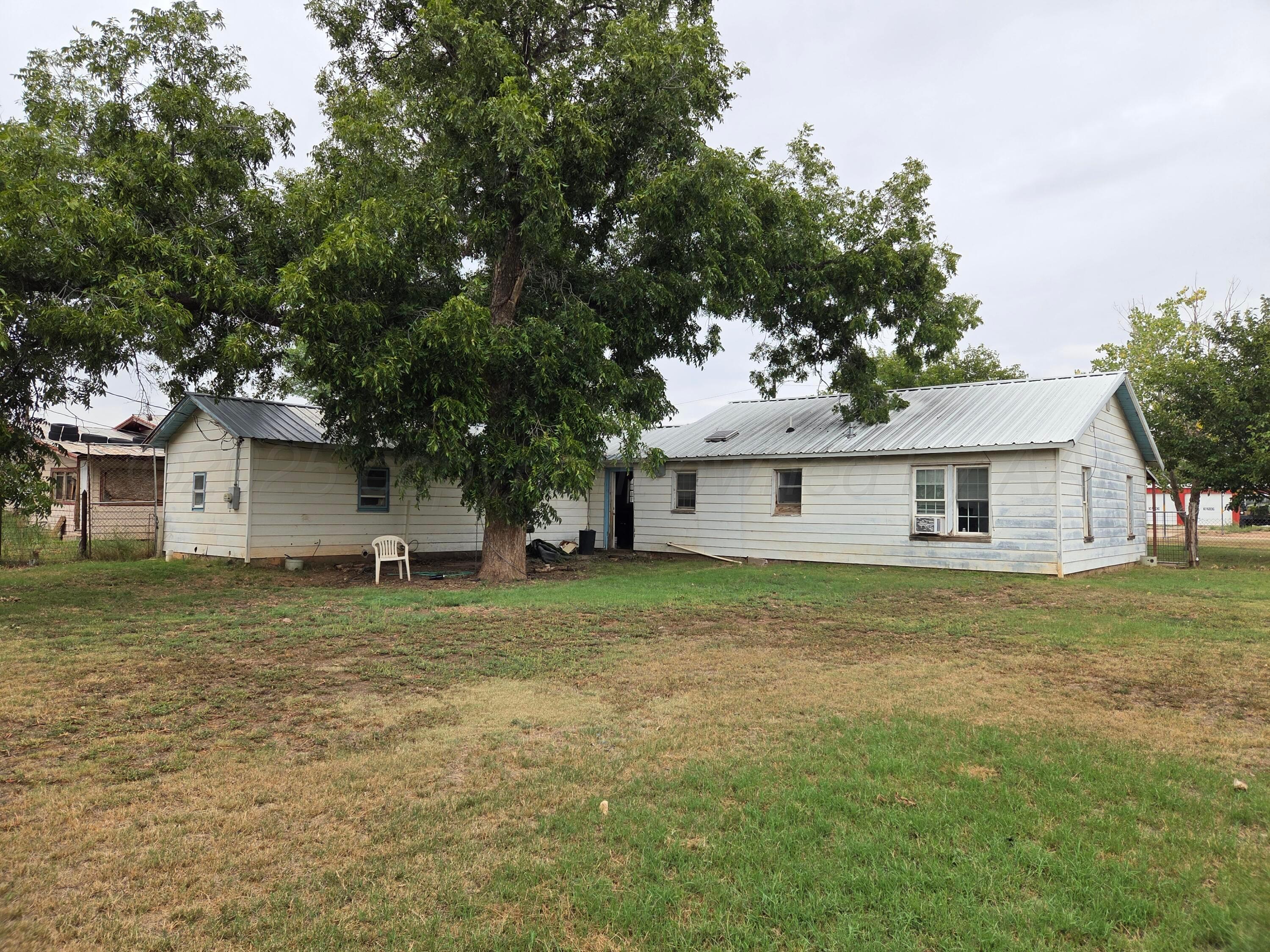 231 Main Street Quitaque, TX 79255 - Photo 22 of 23 a house that is sitting in the grass with large trees