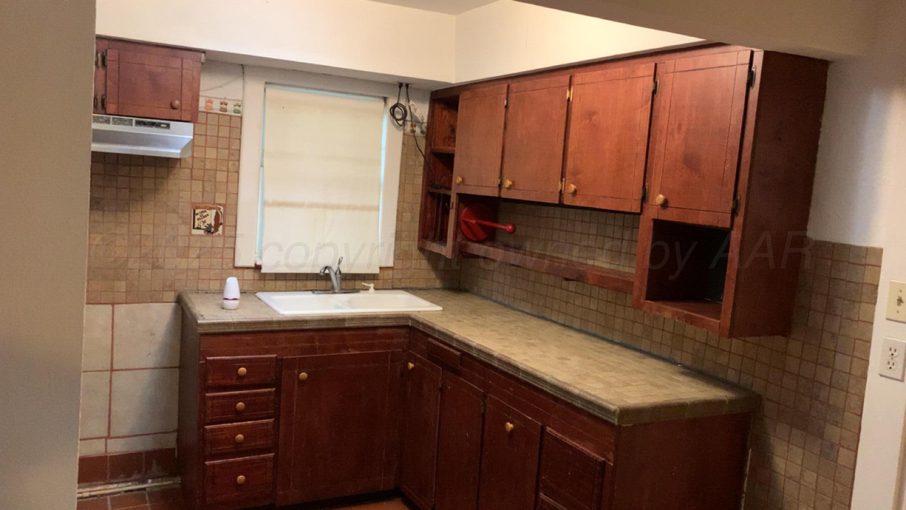 231 Main Street Quitaque, TX 79255 - Photo 8 of 23 a kitchen with a sink and a cabinets