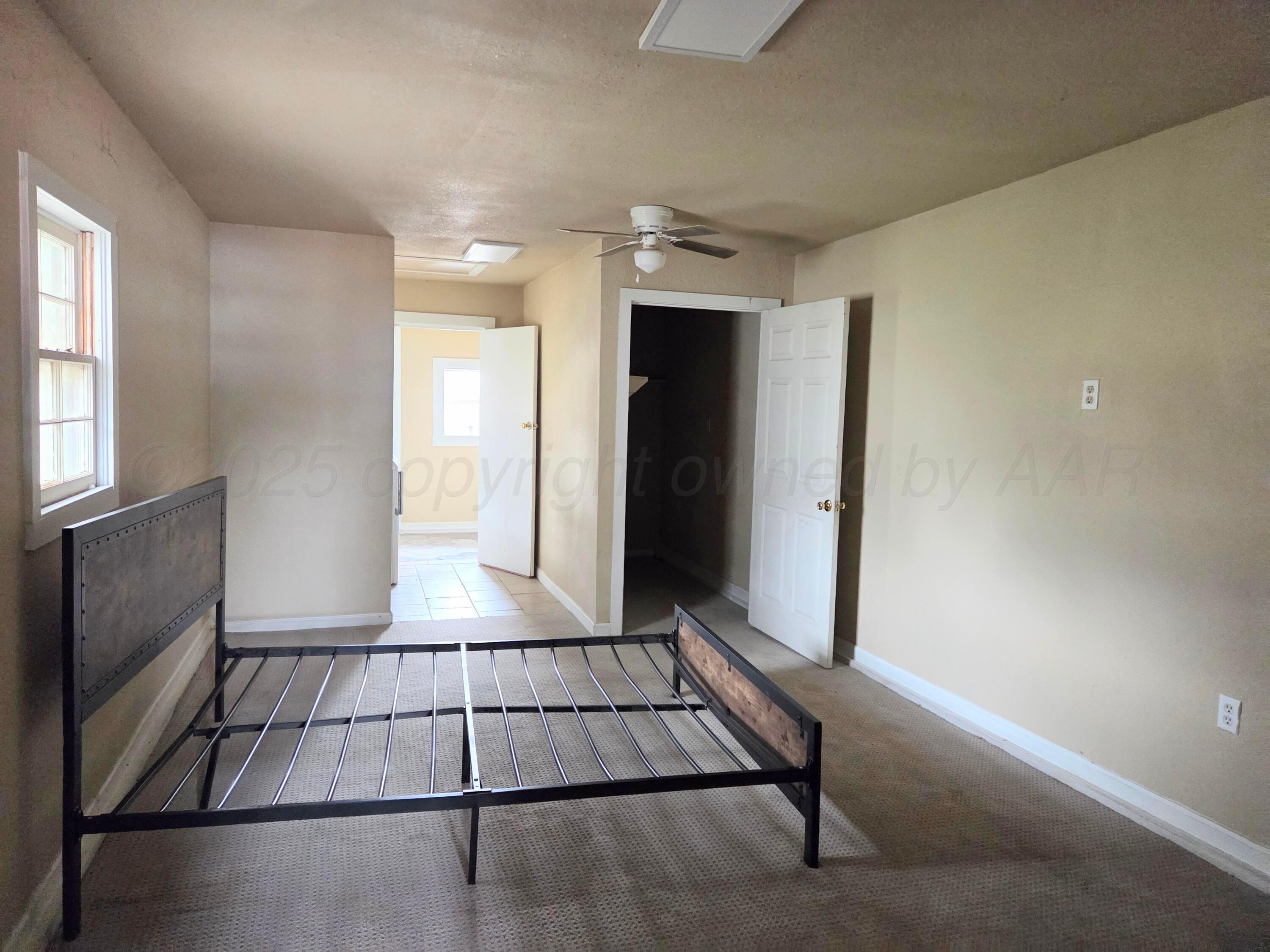 231 Main Street Quitaque, TX 79255 - Photo 10 of 23 a view of a livingroom with wooden floor and kitchen space