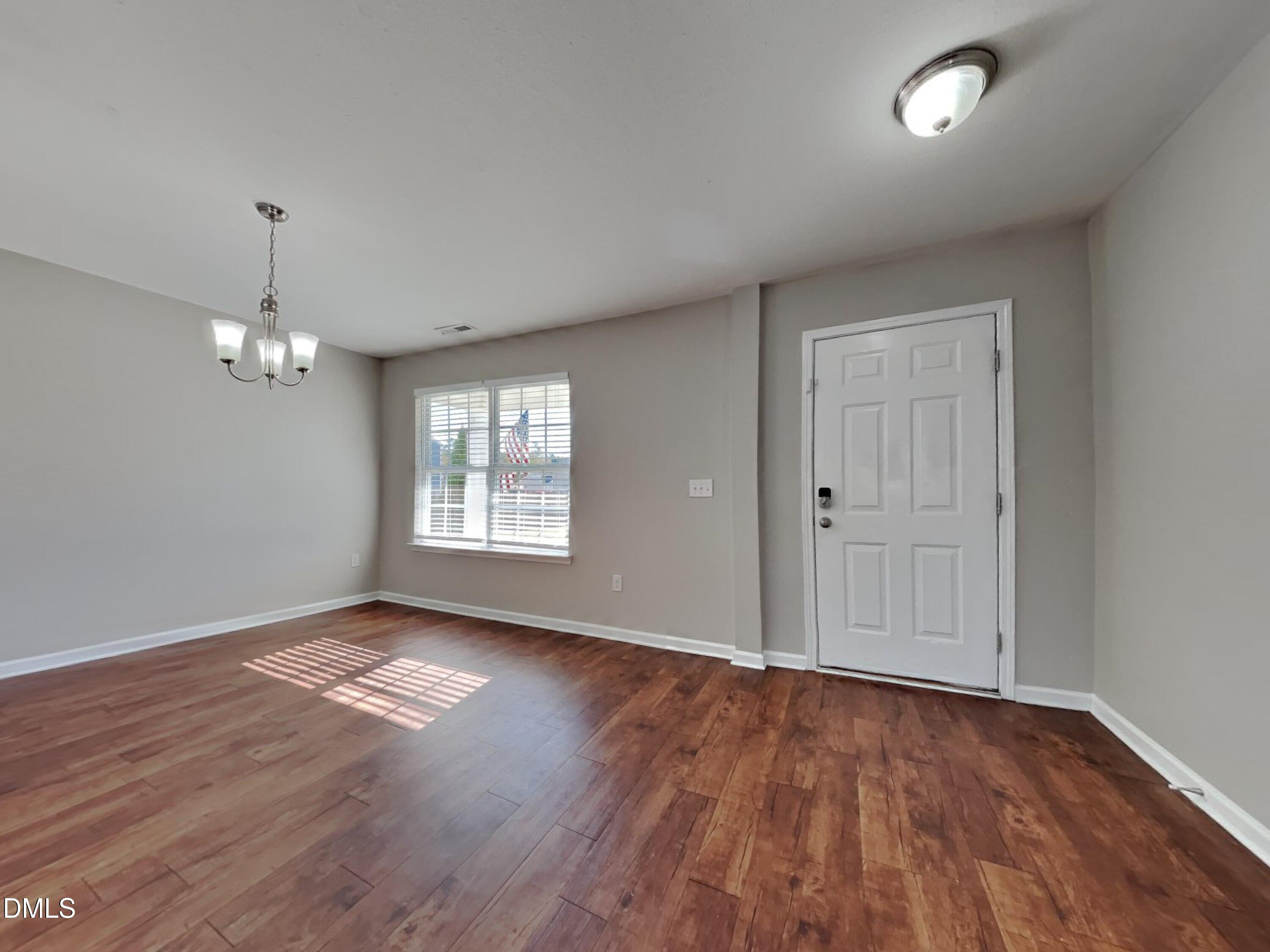 42 Folkstone Court Bunnlevel, NC 28323 - Photo 4 of 20 a view of an empty room with wooden floor and a window