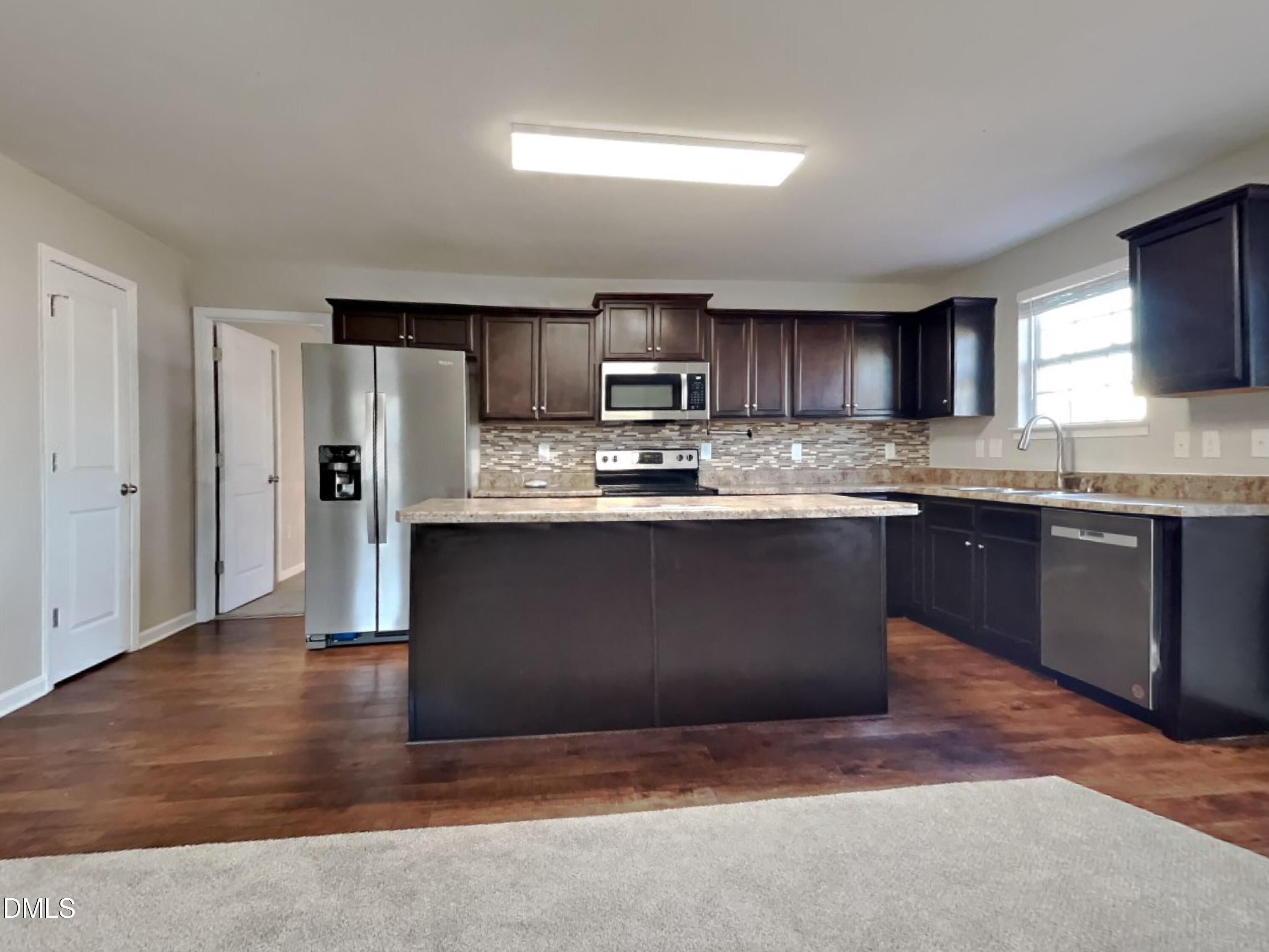 42 Folkstone Court Bunnlevel, NC 28323 - Photo 5 of 20 a kitchen with stainless steel appliances granite countertop a stove a sink dishwasher and a refrigerator