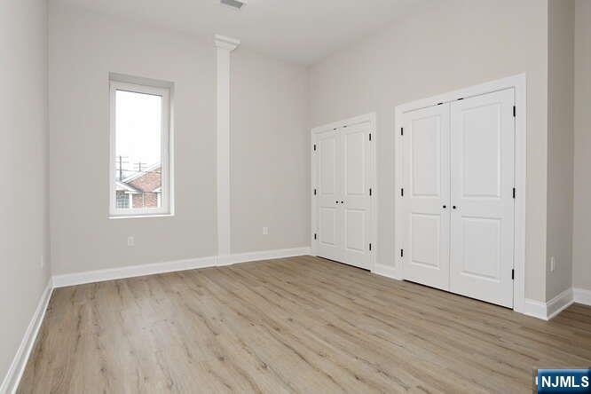 385 Passaic Avenue, Unit 6 Lodi, NJ 07644 - Photo 12 of 23 a view of an empty room with wooden floor