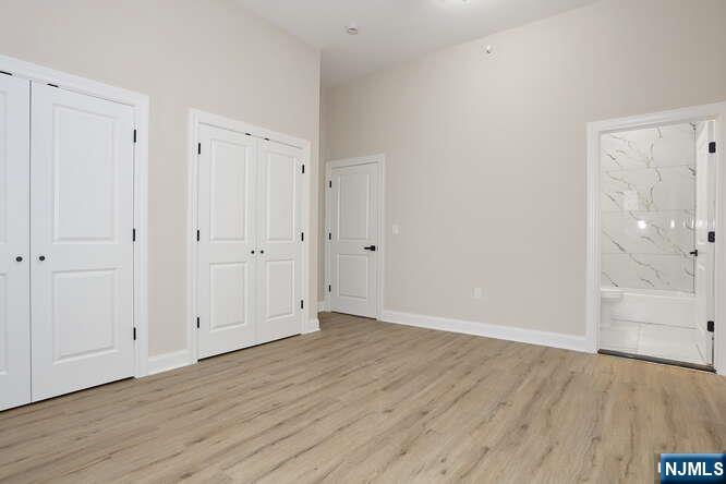 385 Passaic Avenue, Unit 6 Lodi, NJ 07644 - Photo 13 of 23 a view of an empty room with wooden floor
