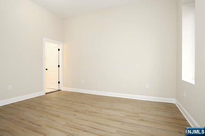 385 Passaic Avenue, Unit 6 Lodi, NJ 07644 - Photo 14 of 23 a view of an empty room with wooden floor